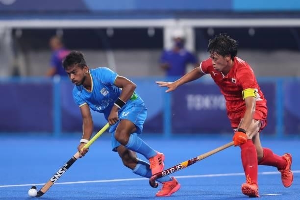 Manabu Yamashita of Team Japan and Vivek Sagar Prasad of Team India battle for the ball during the Men's Preliminary Pool A match between Japan and...