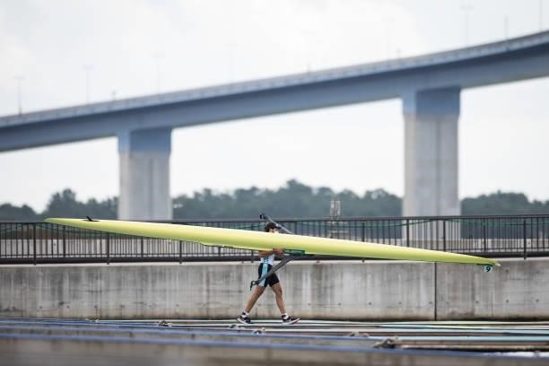An athlete carries his single scull boat towards the water on day seven of the Tokyo 2020 Olympic Games at Sea Forest Waterway on July 30, 2021 in...