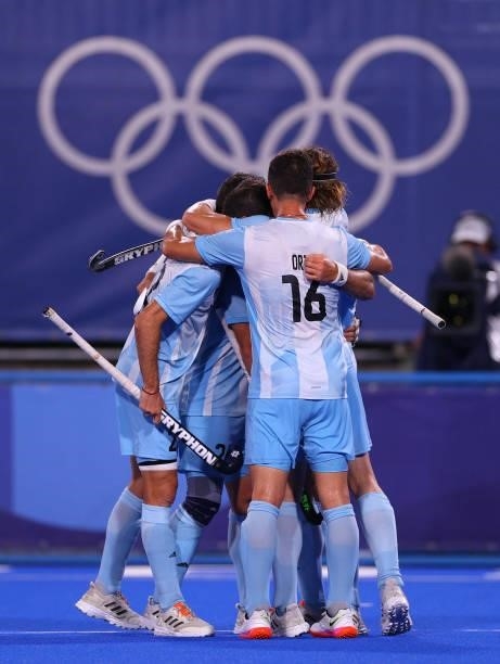 Jose Leandro Tolini of Team Argentina celebrates with teammates after scoring their team's third goal during the Men's Preliminary Pool A match...