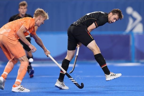 Constantin Staib of Team Germany passes the ball under pressure from Joep Paul Eric de Mol of Team Netherlands during the Men's Preliminary Pool B...