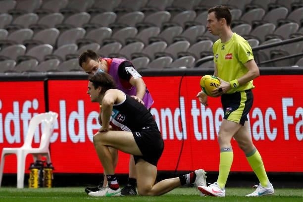 Hunter Clark of the Saints is helped by medical staff during the round 20 AFL match between St Kilda Saints and Carlton Blues at Marvel Stadium on...