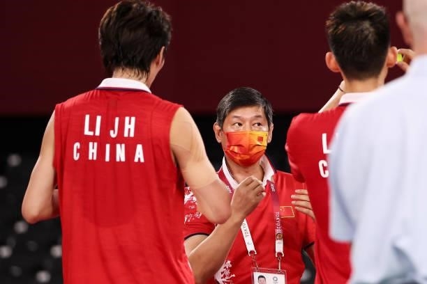Li Jun Hui and Liu Yu Chen of Team China talk to their coach Huang Zhanzhong as they compete against Aaron Chia and Soh Wooi Yik of Team Malaysia...