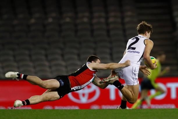 Jack Higgins of the Saints tackles Paddy Dow of the Blues during the round 20 AFL match between St Kilda Saints and Carlton Blues at Marvel Stadium...