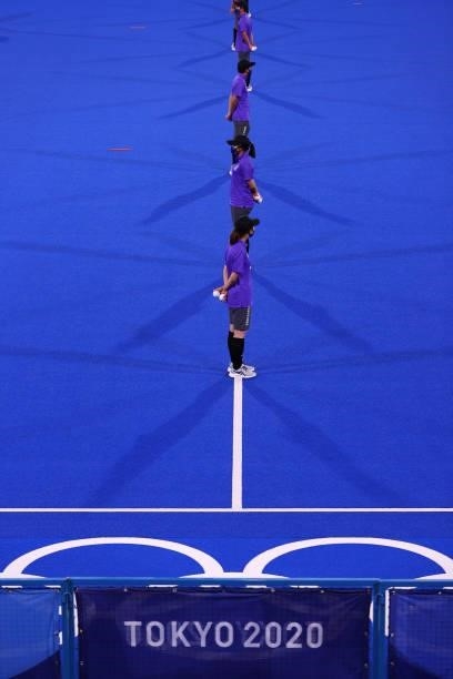 Ball carriers line up on pitch prior to the Men's Preliminary Pool B match between Belgium and Great Britain on day seven of the Tokyo 2020 Olympic...