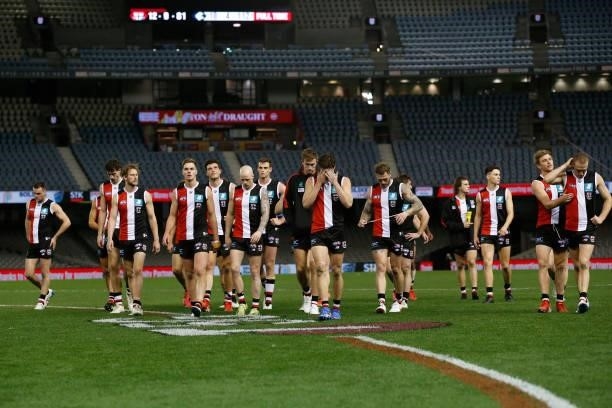 Dejected St Kilda players walk off the ground after the round 20 AFL match between St Kilda Saints and Carlton Blues at Marvel Stadium on July 30,...