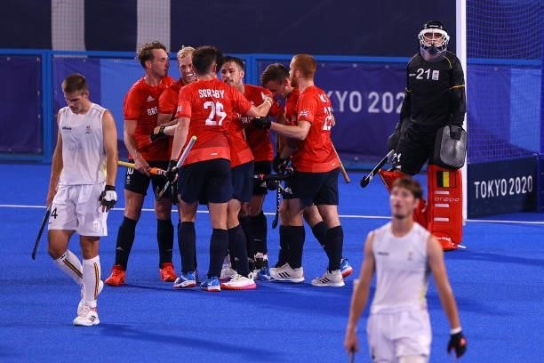 Rupert Scott Shipperley of Team Great Britain celebrates with teammates after scoring their team's first goal during the Men's Preliminary Pool B...