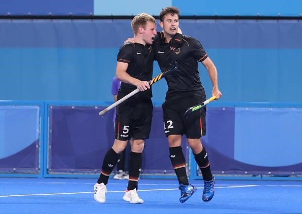 Timm Alexander Herzbruch of Team Germany celebrates with teammate Linus Muller after scoring their team's third goal during the Men's Preliminary...