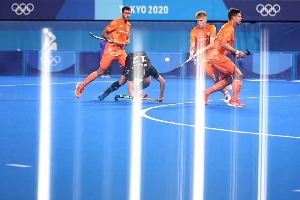 Tim Alexander Herzbruch of Team Germany battles for the ball during the Men's Preliminary Pool B match between Germany and Netherlands on day seven...