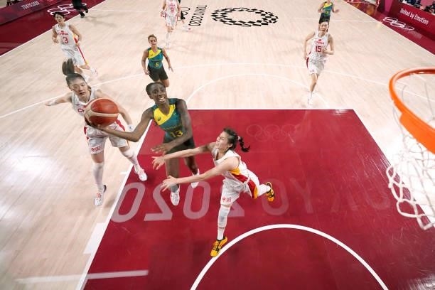 Ezi Magbegor of Team Australia drives to the basket against Siyu Wang and Mengran Sun of Team China during the second half of a Women's Basketball...