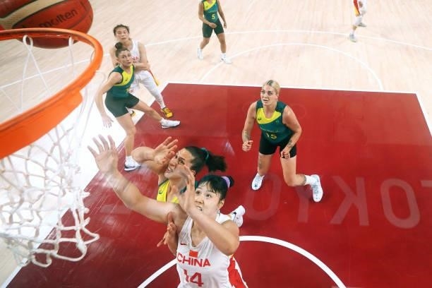 Yueru Li of Team China and Marianna Tolo of Team Australia look for a rebound during the second half of a Women's Basketball Preliminary Round Group...