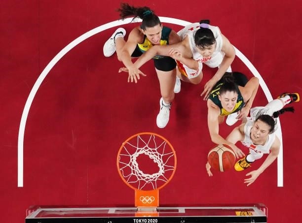 Siyu Wang of Team China drives to the basket against Katie Ebzery of Team Australia as Marianna Tolo and Yueru Li look on during the second half of a...