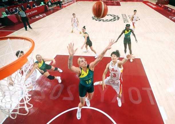 Liwei Yang of Team China drives to the basket against Cayla George of Team Australia during the second half of a Women's Basketball Preliminary Round...