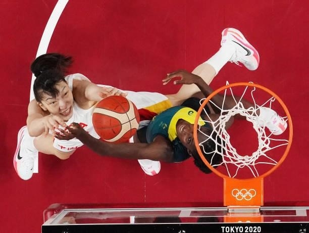 Xu Han of Team China drives to the basket against Ezi Magbegor of Team Australia during the second half of a Women's Basketball Preliminary Round...