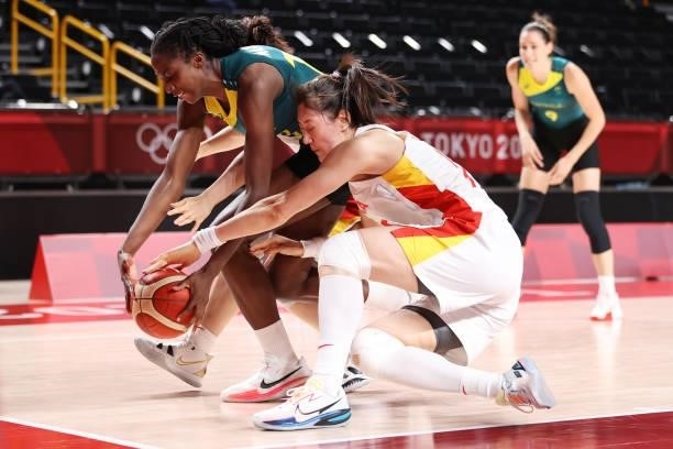 Ezi Magbegor of Team Australia and Mengran Sun of Team China dive for a loose ball during the second half of a Women's Basketball Preliminary Round...