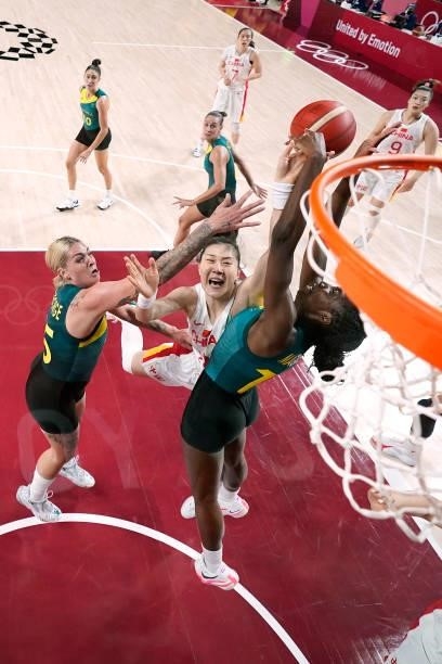 Ezi Magbegor of Team Australia and teammate Cayla George jump up for a rebound against Meng Li of Team China during the first half of a Women's...