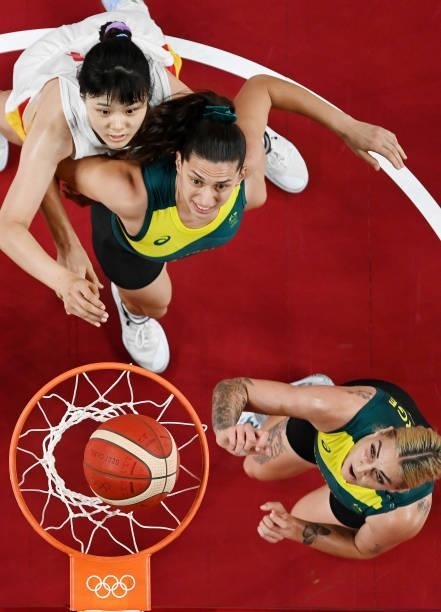 Cayla George and teammate Marianna Tolo of Team Australia box out Yueru Li of Team China as they watch for a rebound during the first half of a...