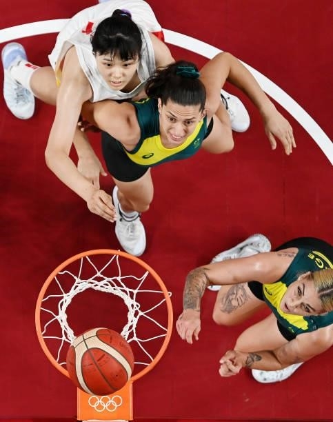Cayla George and teammate Marianna Tolo of Team Australia box out Yueru Li of Team China as they watch for a rebound during the first half of a...
