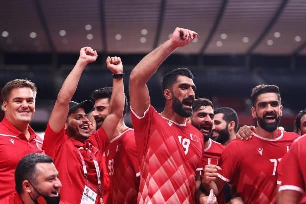 Mohamed Ali of Team Bahrain celebrates with teammates after winning the Men's Preliminary Round Group B handball match between Bahrain and Japan on...