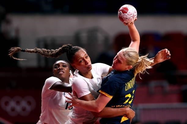 Emma Lindqvist of Team Sweden and Beatrice Edwige of Team France compete for the ball during of the Women's Preliminary Round Group B handball match...