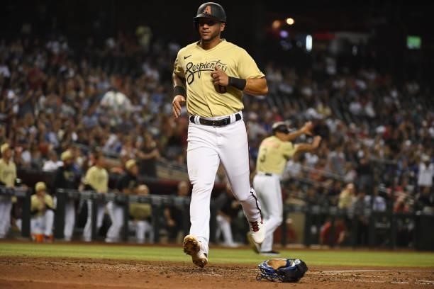 David Peralta of the Arizona Diamondbacks scores on a double by Josh VanMeter against the Los Angeles Dodgers during the second inning at Chase Field...