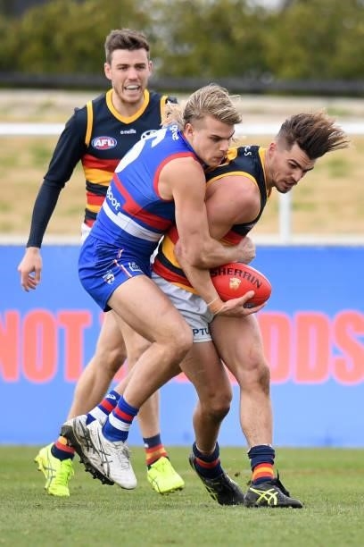 Bailey Smith of the Bulldogs tackles Ben Keays of the Crows during the round 19 AFL match between Western Bulldogs and Adelaide Crows at Mars Stadium...