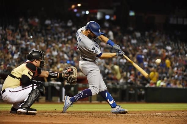 Chris Taylor of the Los Angeles Dodgers hits a two run triple against the Arizona Diamondbacks during the seventh inning at Chase Field on July 30,...
