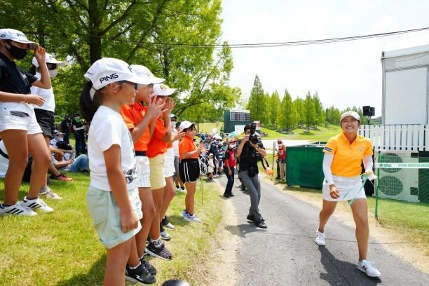Mone Inami of Japan smiles as she is cheered by young fans after holing out following the final round of Rakuten Super Ladies at Tokyu Grand Oak Golf...