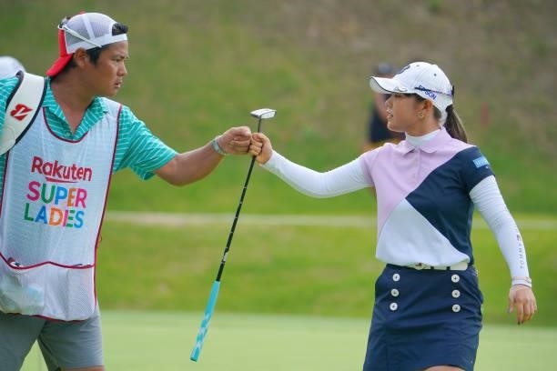 Yuri Yoshida of Japan fist bumps with her caddie after the birdie on the 14th green during the final round of Rakuten Super Ladies at Tokyu Grand Oak...