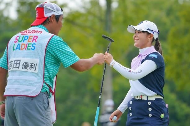 Yuri Yoshida of Japan fist bumps with her caddie after the birdie on the 15th green during the final round of Rakuten Super Ladies at Tokyu Grand Oak...