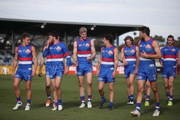 Bulldogs players exit the field following the round 19 AFL match between Western Bulldogs and Adelaide Crows at Mars Stadium on July 31, 2021 in...