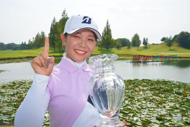 Yuri Yoshida of Japan poses with the trophy after winning the tournament following the final round of Rakuten Super Ladies at Tokyu Grand Oak Golf...