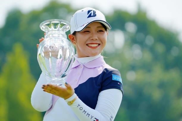 Yuri Yoshida of Japan poses with the trophy after winning the tournament following the final round of Rakuten Super Ladies at Tokyu Grand Oak Golf...