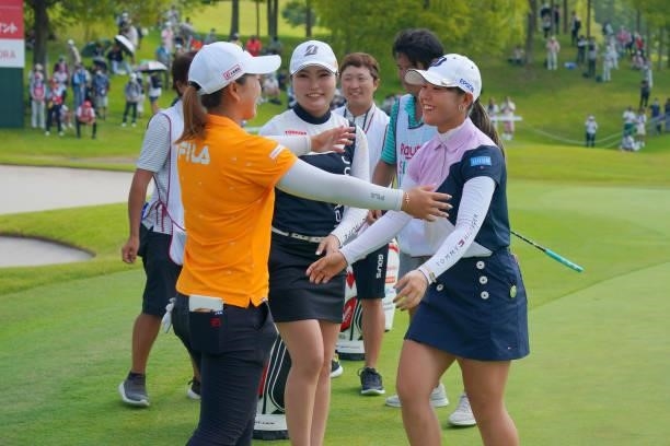 Yuri Yoshida of Japan is congratulated by Mao Saigo after winning the tournament on the 18th green during the final round of Rakuten Super Ladies at...