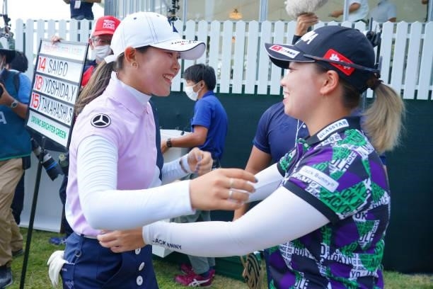 Yuri Yoshida of Japan is congratulated by Miyu Goto after winning the tournament on the 18th green during the final round of Rakuten Super Ladies at...