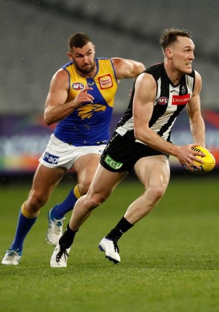 Jack Darling of the Eagles chases Jack Madgen of the Magpies during the round 20 AFL match between Collingwood Magpies and West Coast Eagles at...