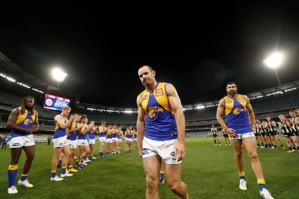 Shannon Hurn of the Eagles is acknowledged by both teams after playing in his 300th game during the round 20 AFL match between Collingwood Magpies...