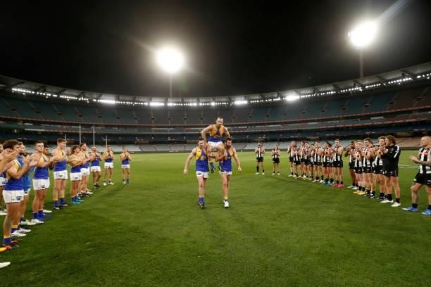 Shannon Hurn of the Eagles is acknowledged by both teams after playing in his 300th game during the round 20 AFL match between Collingwood Magpies...