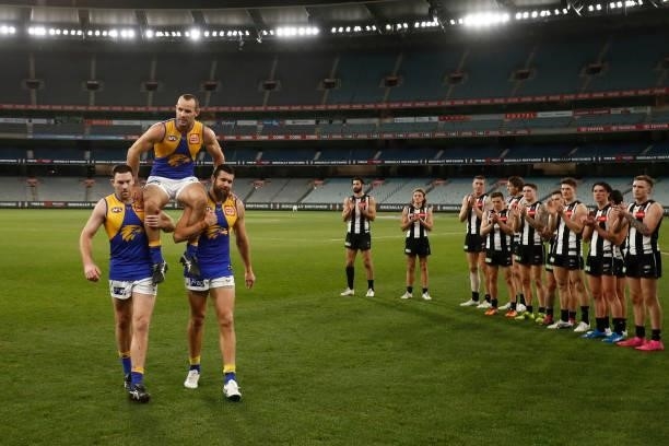 Shannon Hurn of the Eagles is chaired from the ground after playing in his 300th game during the round 20 AFL match between Collingwood Magpies and...