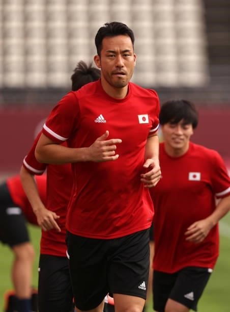 Maya Yoshida of Team Japan looks on as he warms up prior to the Men's Quarter Final match between Japan and New Zealand on day eight of the Tokyo...