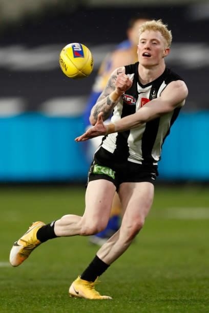 John Noble of the Magpies handballs during the round 20 AFL match between Collingwood Magpies and West Coast Eagles at Melbourne Cricket Ground on...