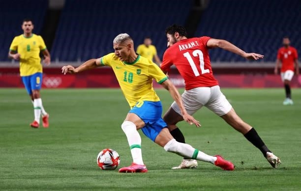 Richarlison of Team Brazil battles for possession with Akram Tawfik of Team Egypt during the Men's Quarter Final between Brazil and Egypt on day...