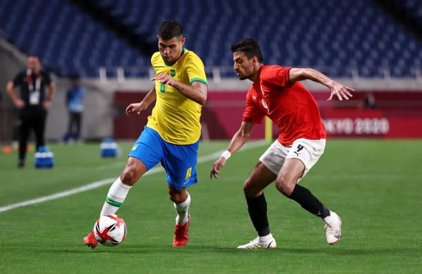 Bruno Guimaraes of Team Brazil battles for possession with Taher Mohamed of Team Egypt during the Men's Quarter Final between Brazil and Egypt on day...