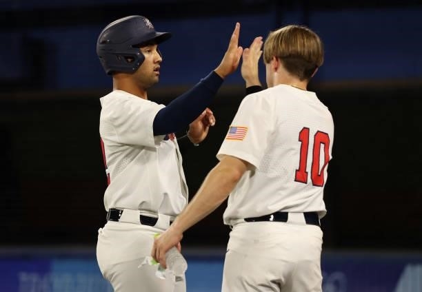 Jamie Westbrook of Team United States celebrates with teammate Nicholas Allen in the fifth inning during the baseball opening round Group B game...