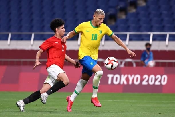 Richarlison of Team Brazil battles for possession with Ammar Hamdy of Team Egypt during the Men's Quarter Final between Brazil and Egypt on day eight...