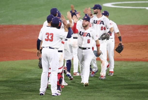 Eric Filia of Team United States celebrates winning the match 4-2 with teammates during the baseball opening round Group B game between Team South...