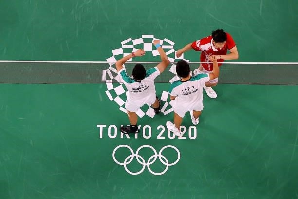 Lee Yang and Wang Chi-Lin of Team Chinese Taipei greets their opponents Li Jun Hui and Liu Yu Chen of Team China after winning the Men’s Doubles Gold...