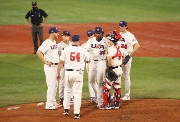Mike Scioscia, Team manager of Team United States talks to Edwin Jackson Jr of Team United States during the baseball opening round Group B game...
