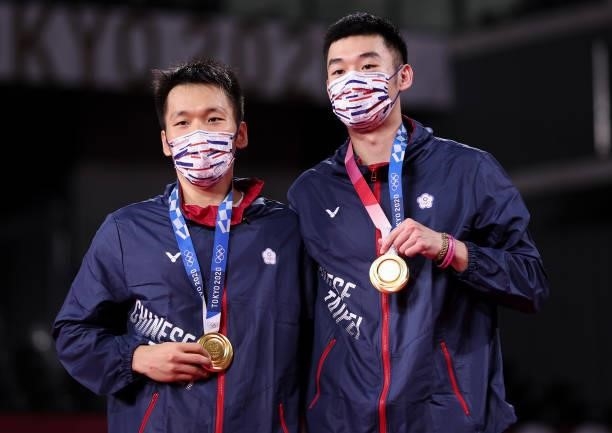 Gold medalists Lee Yang and Wang Chi-Lin of Team Chinese Taipei pose on the podium during the medal ceremony for the Men’s Doubles badminton event on...