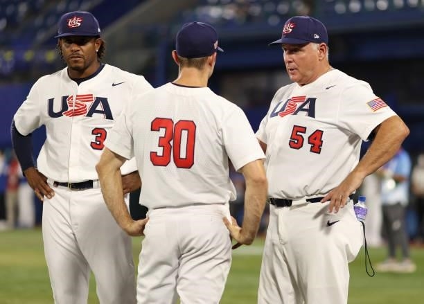 Mike Scioscia, Team manager of Team United States talks to David Robertson and Edwin Jackson Jr of Team United States after winning the match 4-2...