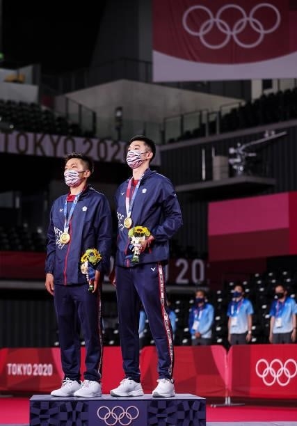 Gold medalists Lee Yang and Wang Chi-Lin of Team Chinese Taipei pose on the podium during the medal ceremony for the Men’s Doubles badminton event on...
